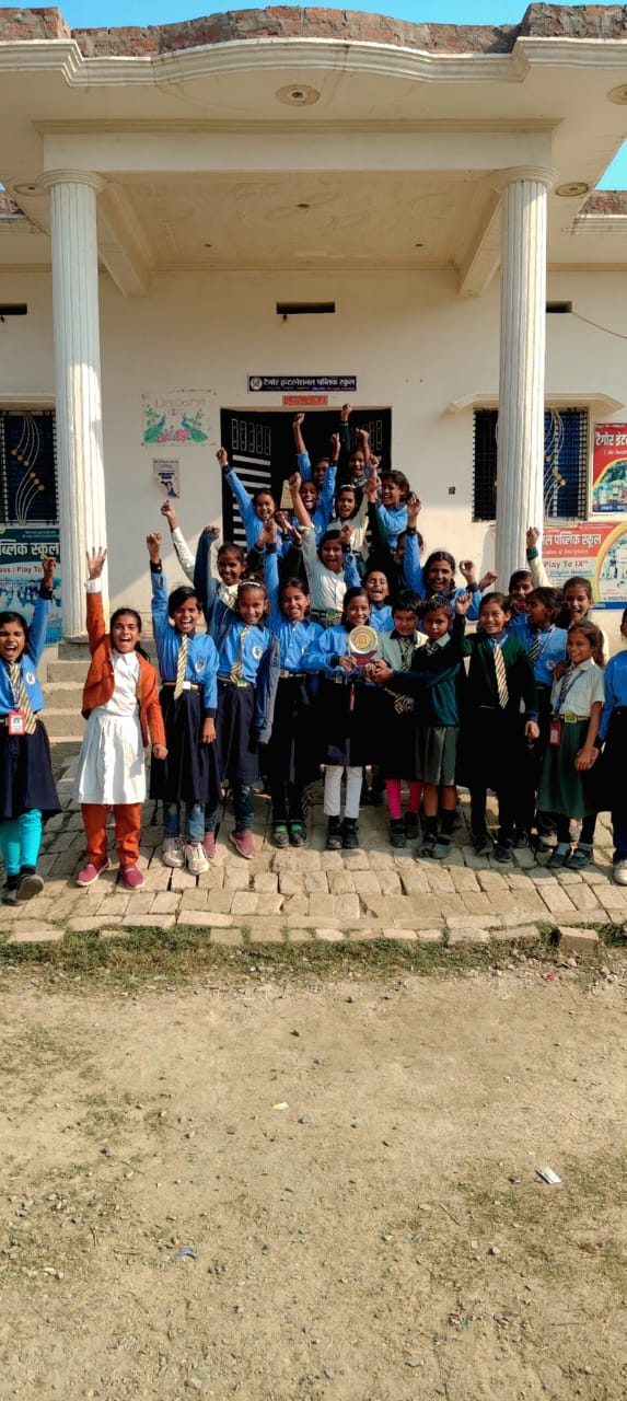 Students celebrating with trophy